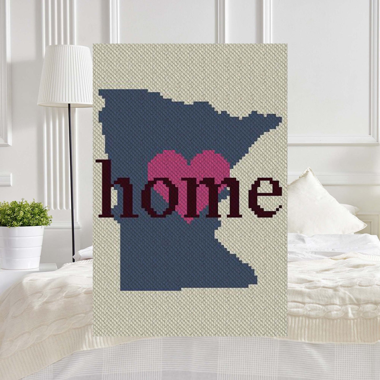 Pixel-art Minnesota outline in four contrasting yarn blocks