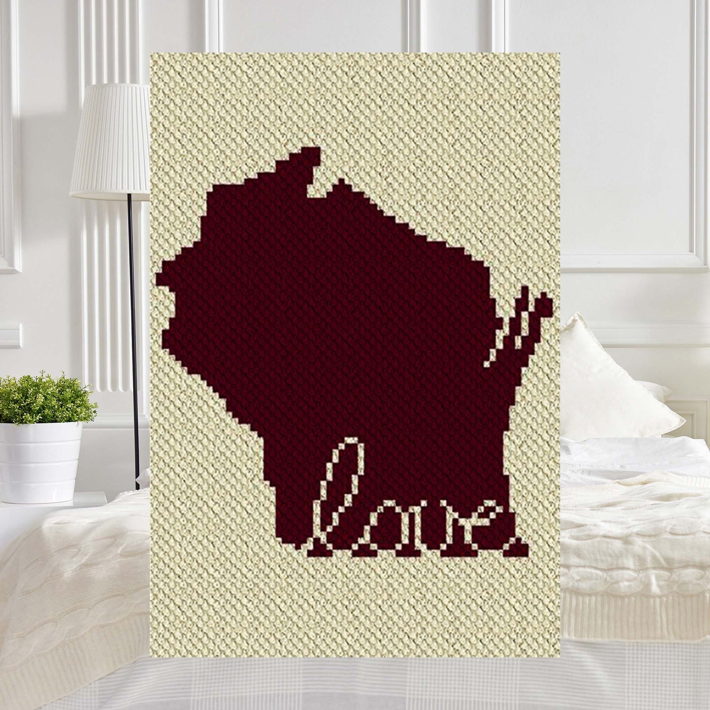 Pixel-art Wisconsin state outline with a heart motif in two contrasting yarn blocks