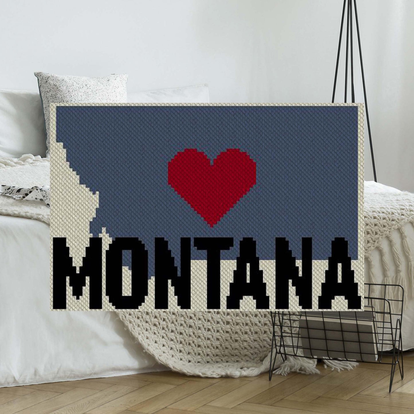 Pixel-art Montana outline with a heart in four contrasting yarn blocks
