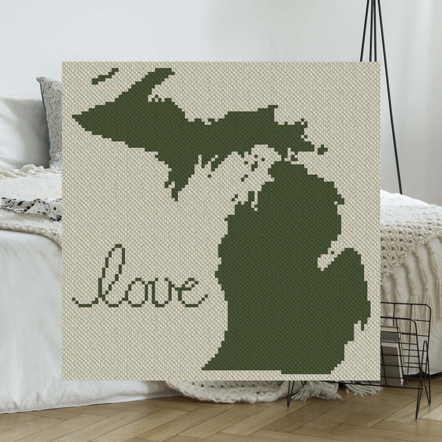 Pixel-art Michigan state outline with a heart in two contrasting yarn blocks