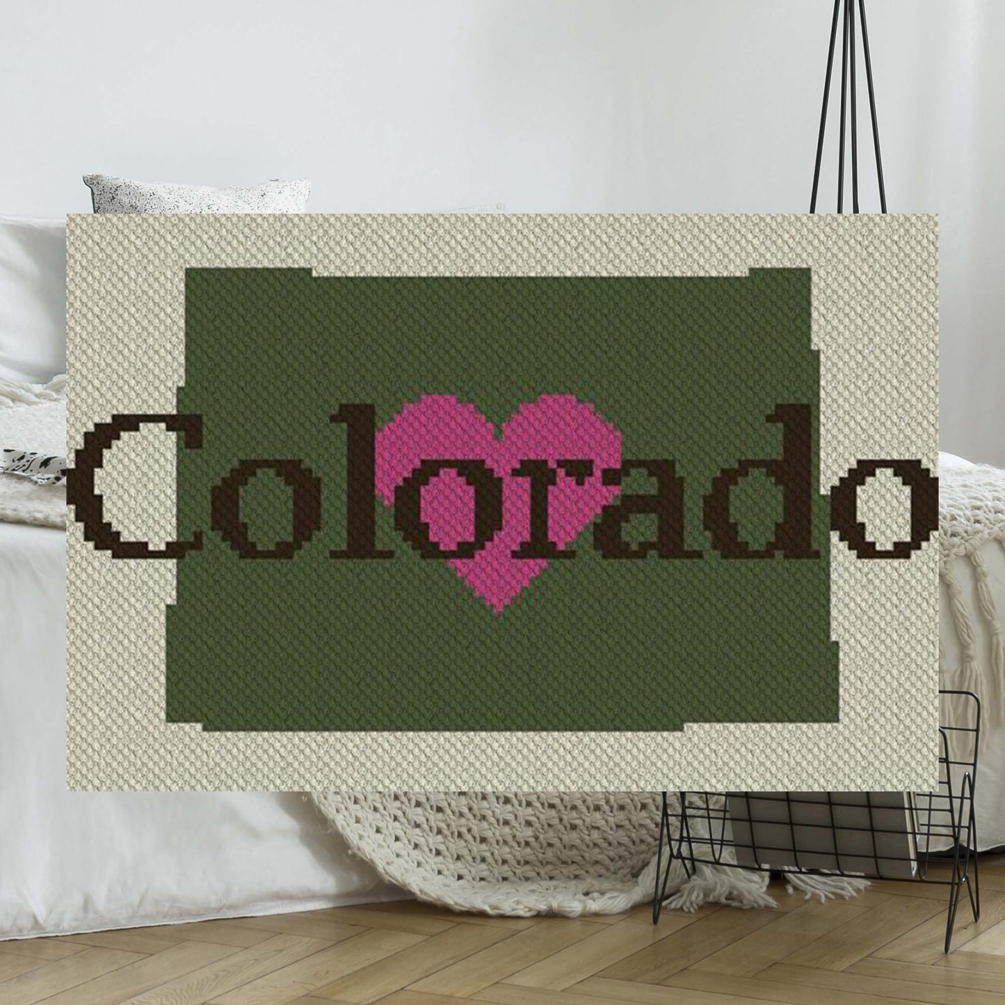 Pixel-art Colorado silhouette with a heart in contrasting yarn blocks