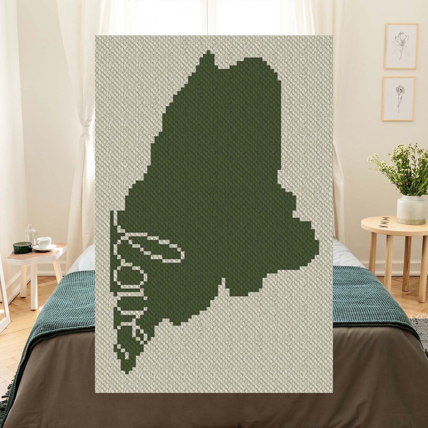 Pixel-art Maine silhouette with a heart in two contrasting yarn blocks
