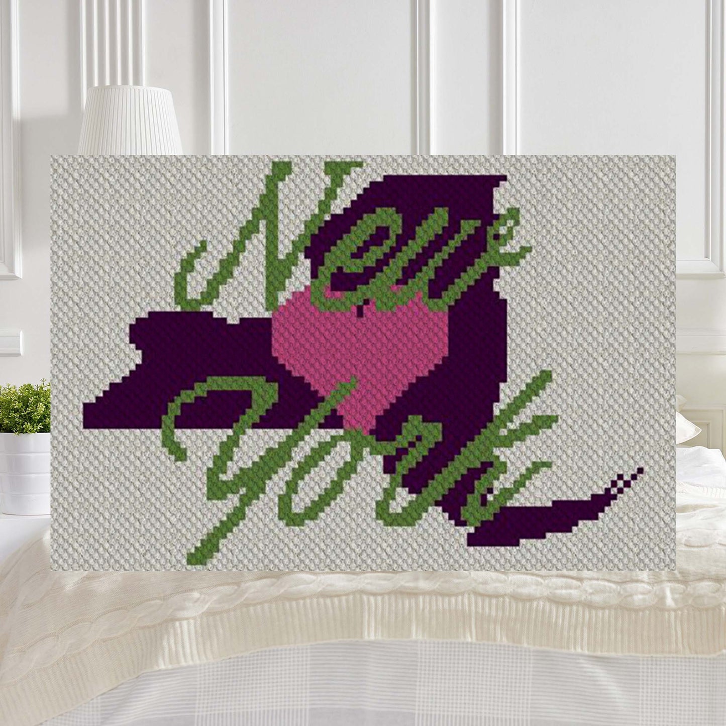 Pixel-art New York outline with heart in two contrasting yarn blocks