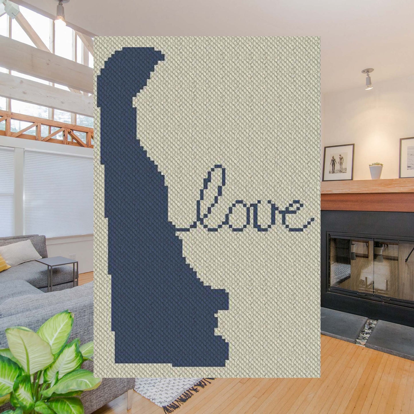 Pixel-art Delaware outline with a heart motif in two contrasting yarn colors