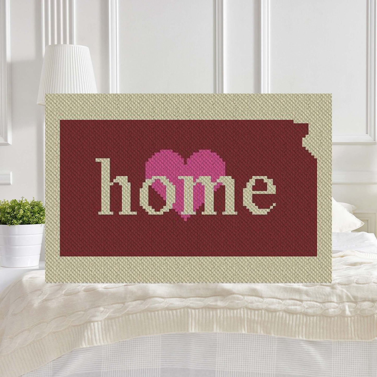 Pixel-art Kansas silhouette in contrasting yarn blocks