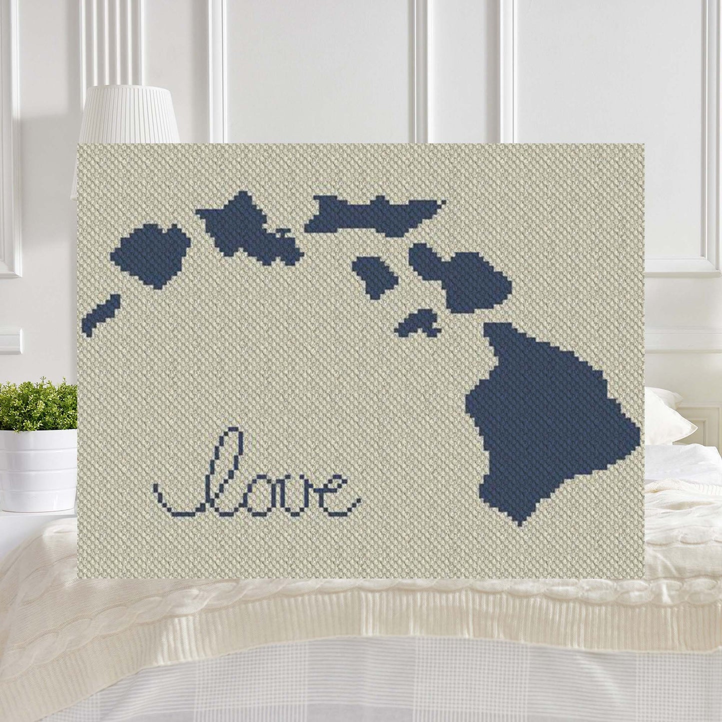 Pixel-art Hawaii silhouette with a centered heart in two contrasting yarn colors