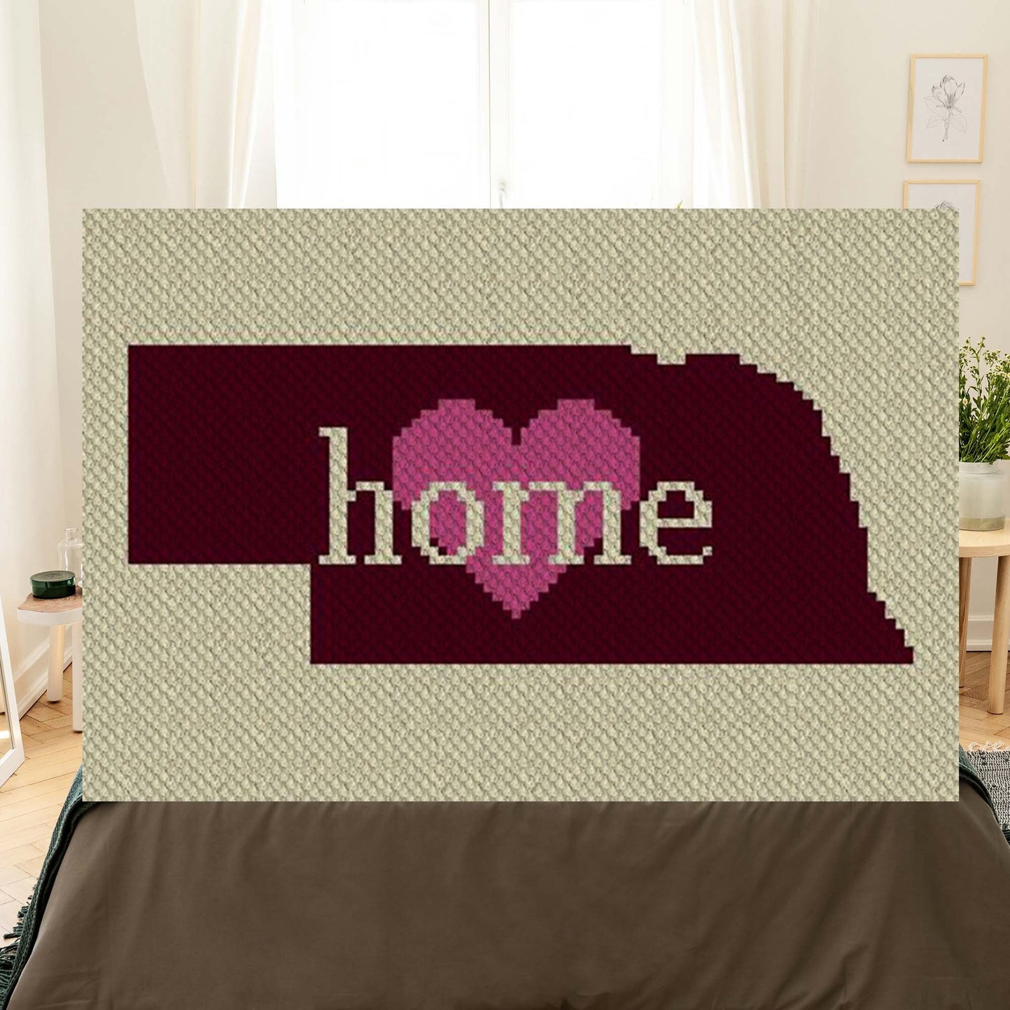 Pixel-art Nebraska outline in three yarn colors