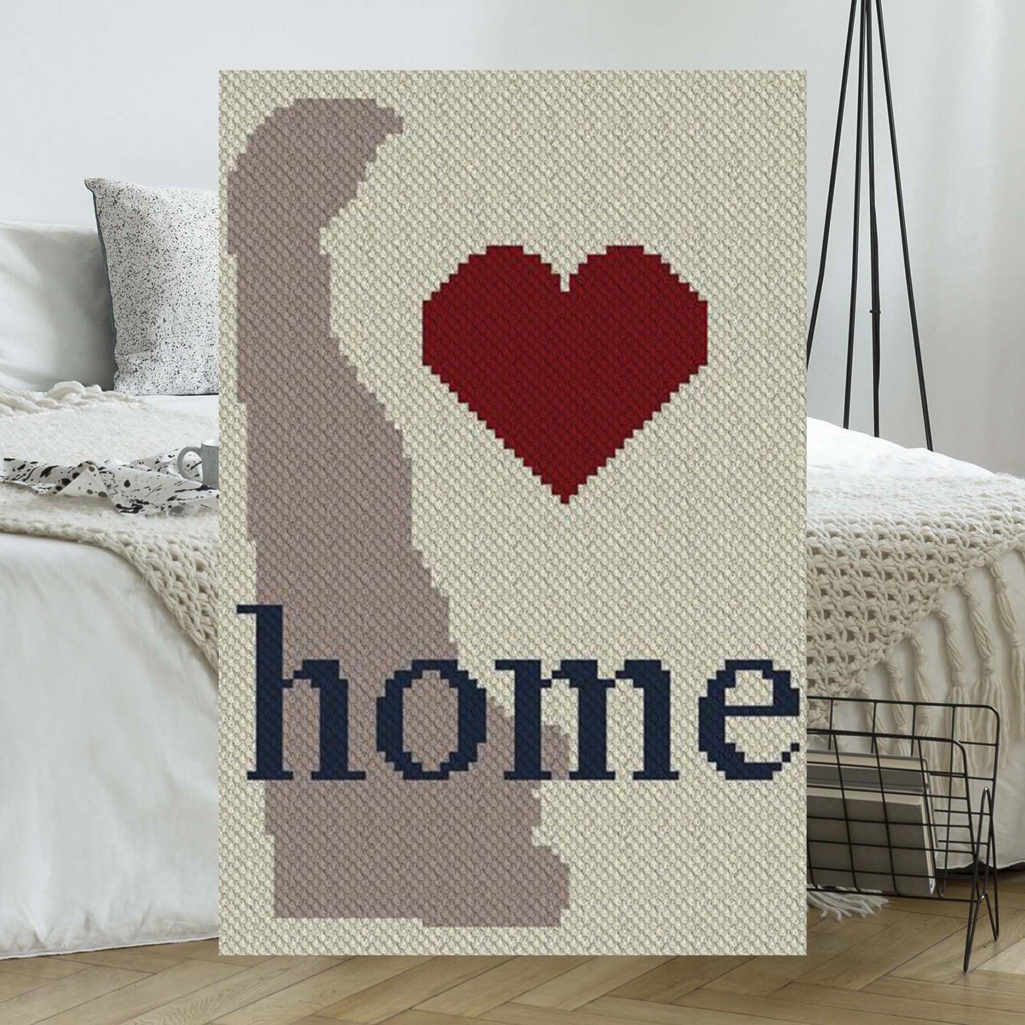 Pixel-art Delaware state outline rendered in four complementary yarn colors