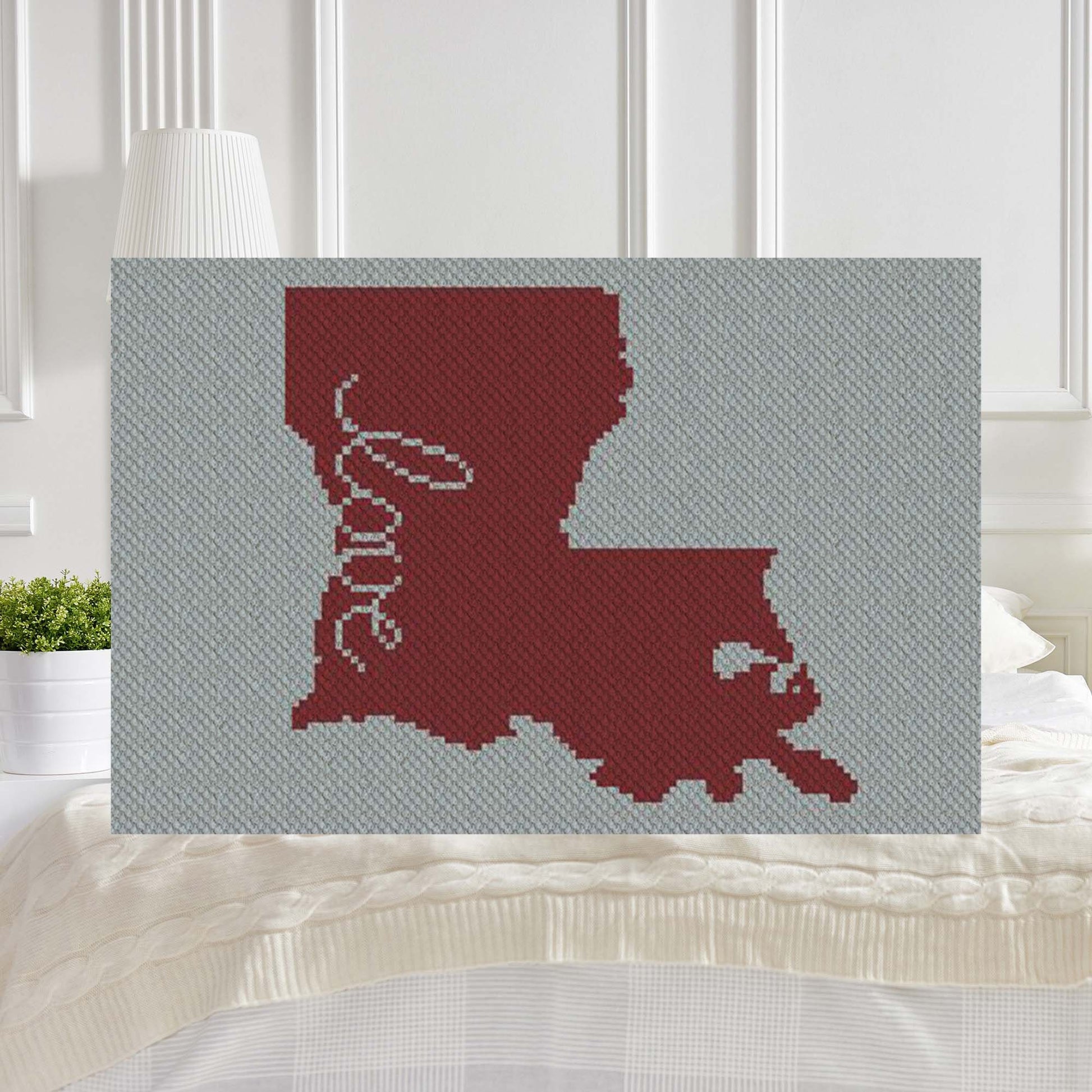 Pixel-art Louisiana silhouette with a heart in two contrasting yarn blocks
