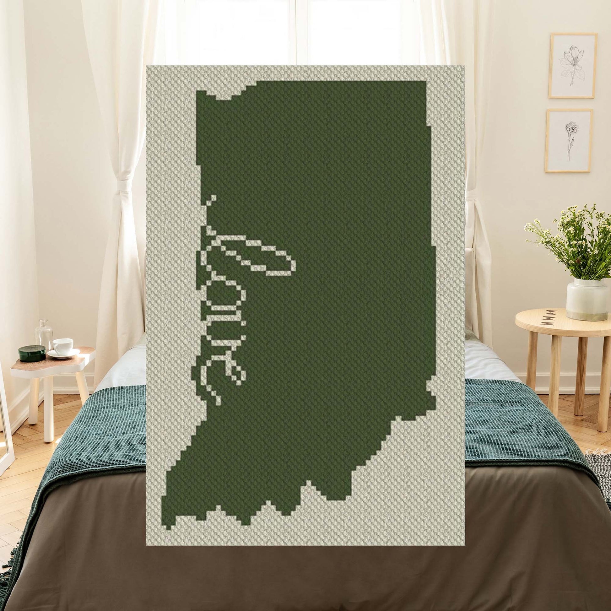 Pixel-art Indiana outline in three contrasting yarn colors