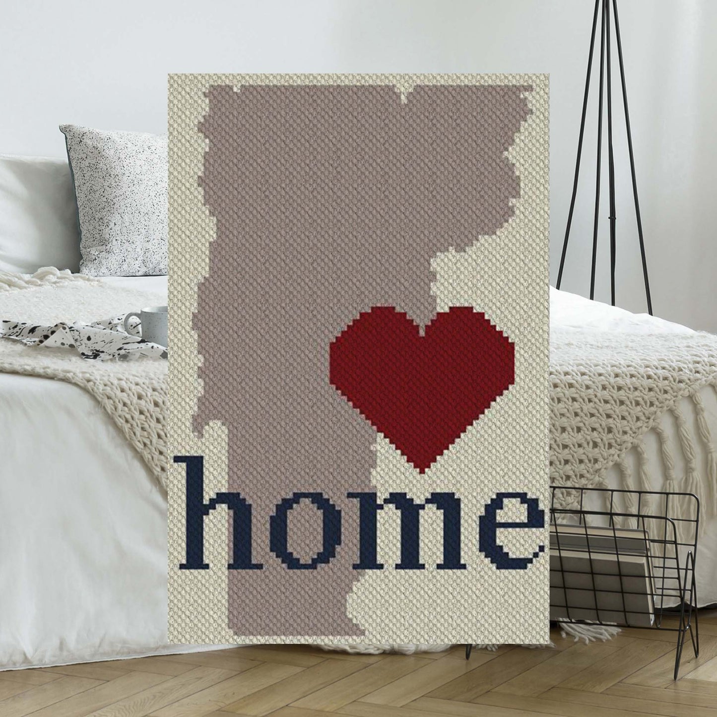 Pixel-art Vermont state outline in four coordinating yarn blocks