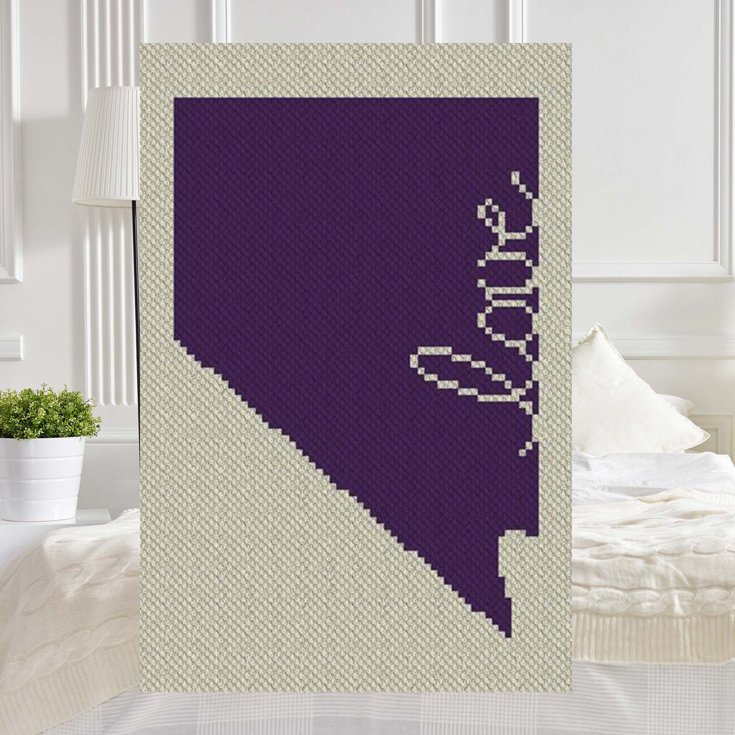 Pixel-art Nevada silhouette with a heart in two contrasting yarn blocks