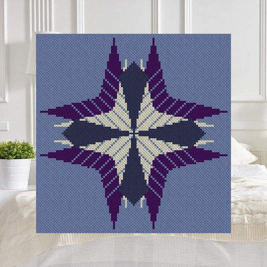 Geometric starburst afghan in shades of purple and blue, rendered in corner-to-corner pixel blocks