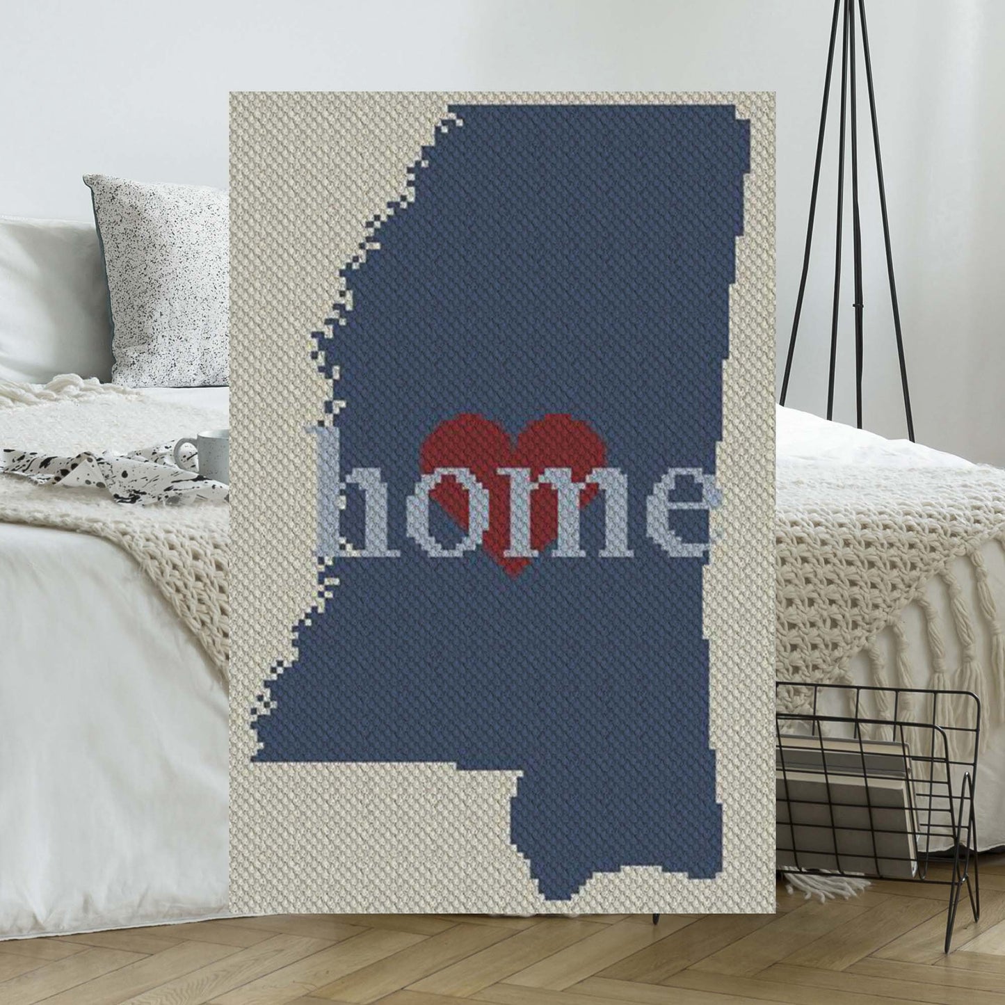 Pixel-art Mississippi outline in four yarn colors