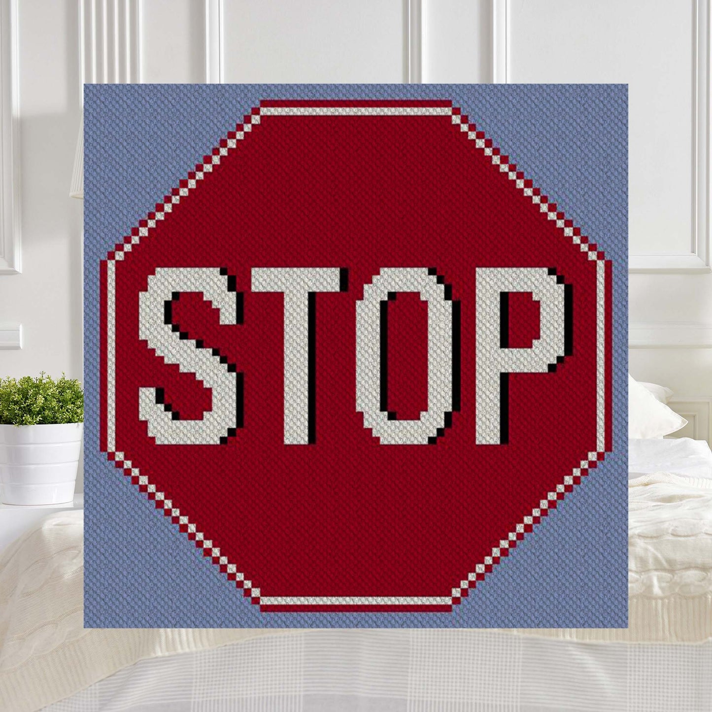Pixel-art red stop sign octagon with bold white STOP†lettering on a light blue background rendered in C2C blocks