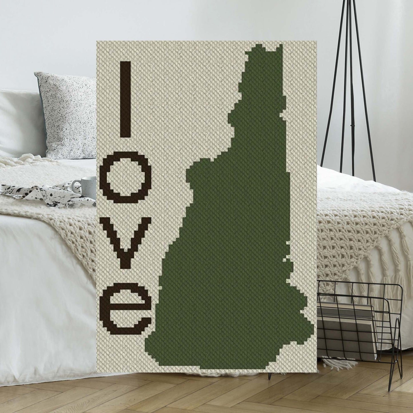 Pixel-art New Hampshire outline with heart motif in three contrasting yarn blocks