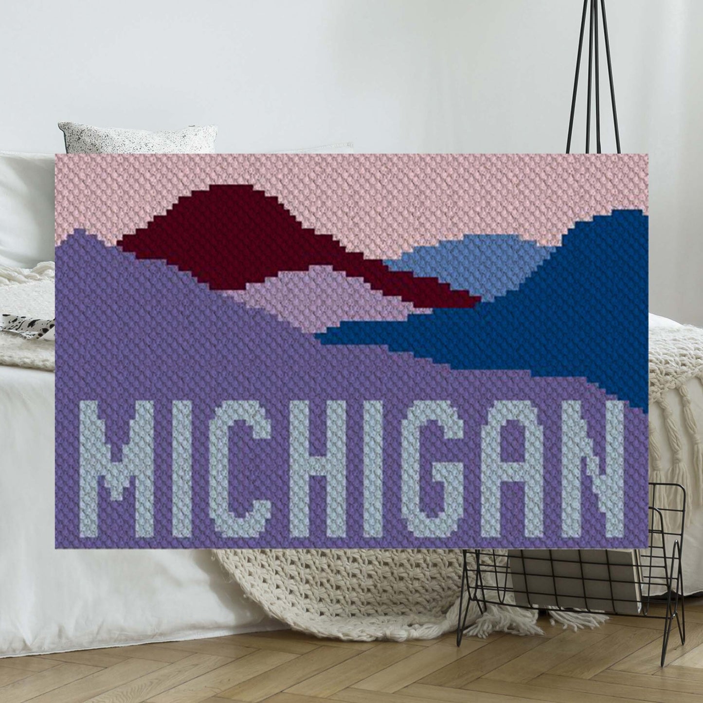 Stylized Michigan mountain range silhouette with layered peaks charted in block and word formats
