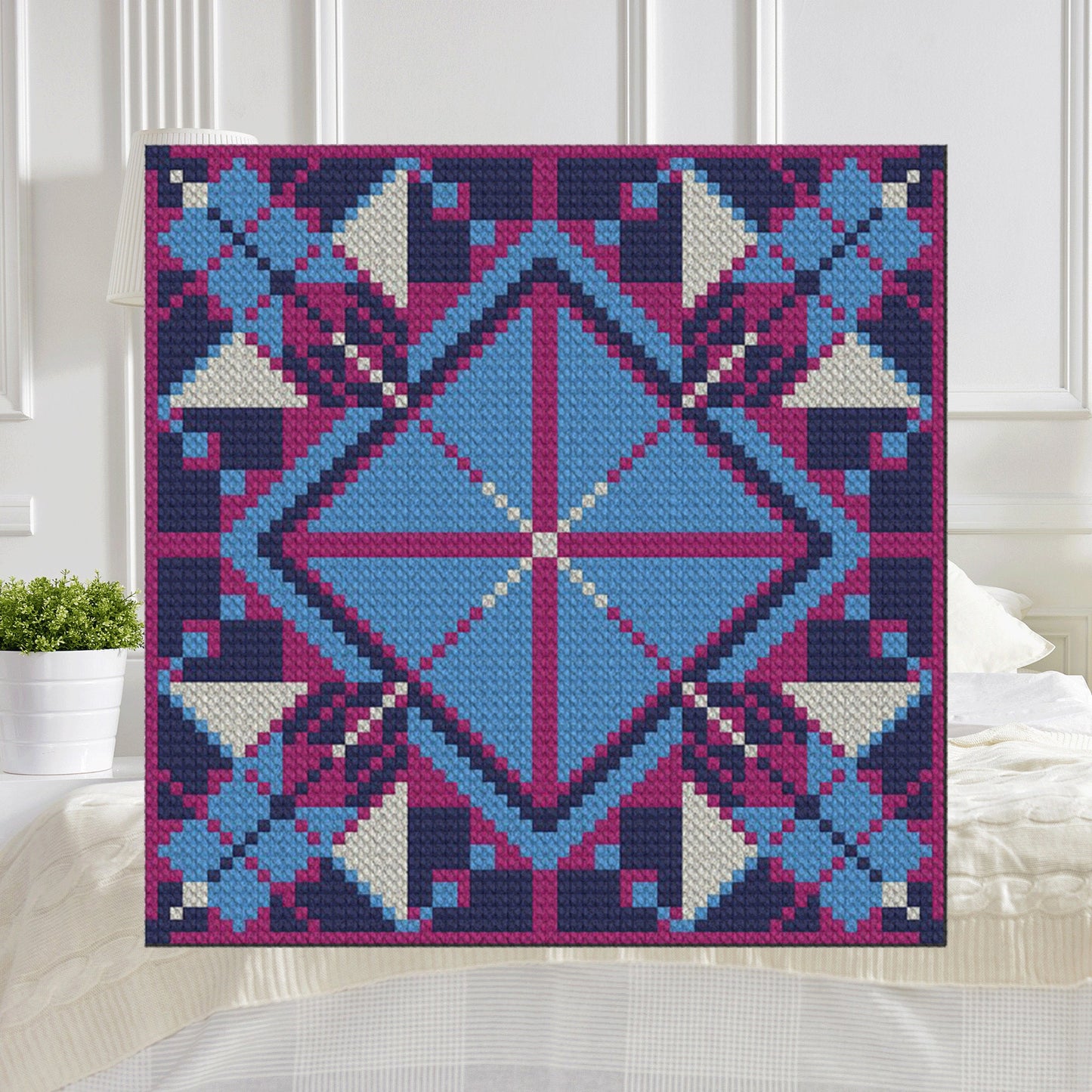 Bright blue diamond framed by magenta & navy pierced cross motifs in pixel blocks