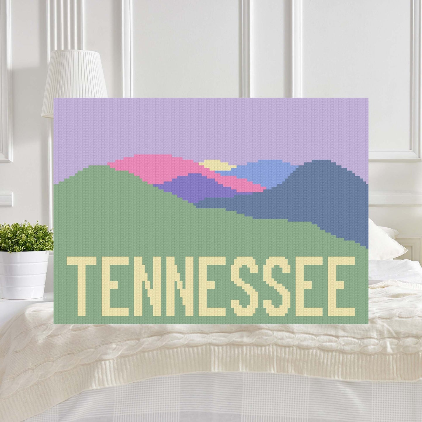 Pixel-art mountain range in purples, pinks, greens & a sunrise, with TENNESSEE†spelled out in block letters across the base