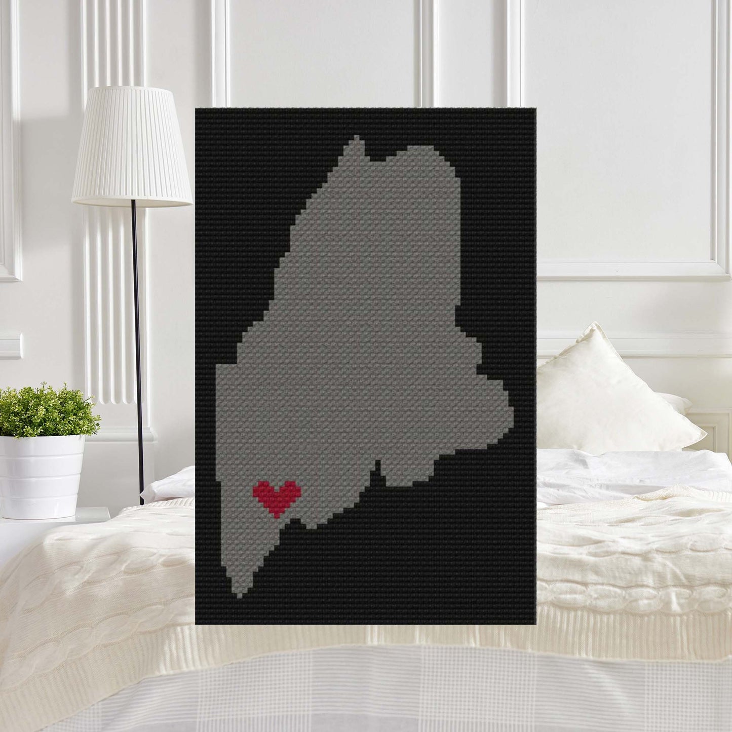 Pixel-art Maine silhouette filled with a heart and the word Strong†in contrasting yarn blocks